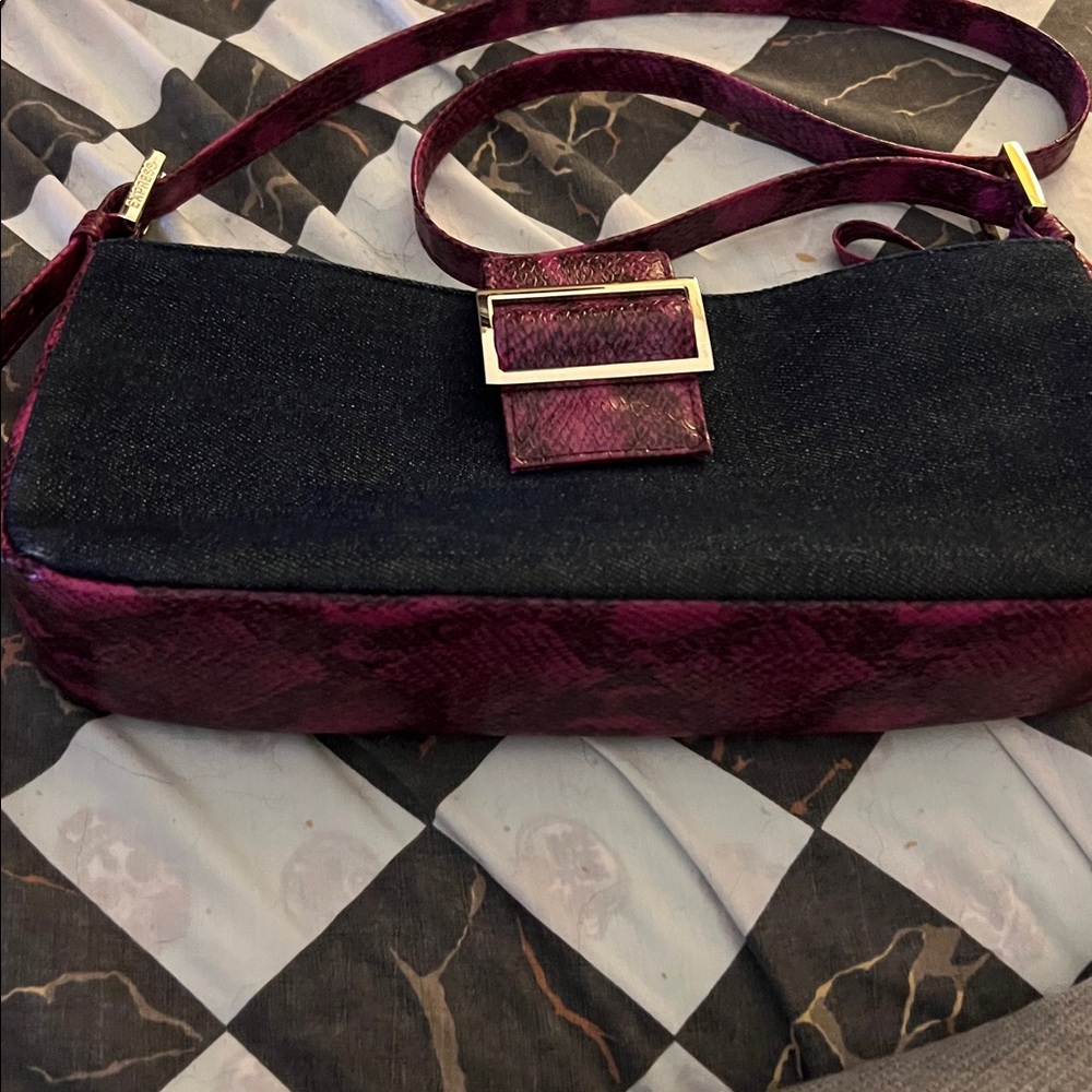 Express blue Jean, material and pinkish purple snake  trimming on  Bag

11x5